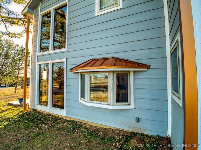 view of side of property with a standing seam roof and metal roof