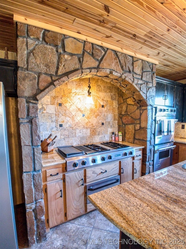 kitchen featuring stainless steel appliances, light tile patterned flooring, wood ceiling, and light stone countertops