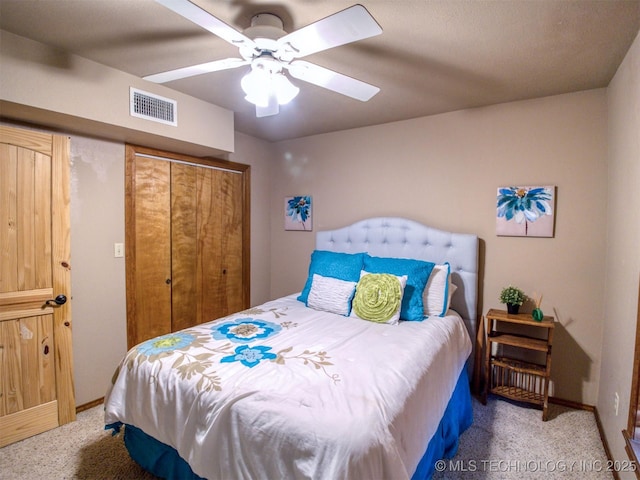 carpeted bedroom featuring ceiling fan, a closet, visible vents, and baseboards