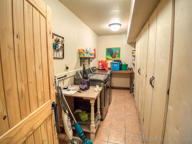 office featuring a textured ceiling, separate washer and dryer, and light tile patterned flooring