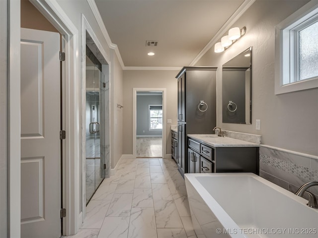 bathroom featuring a freestanding tub, visible vents, vanity, marble finish floor, and crown molding