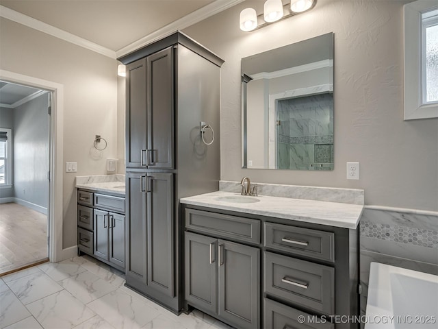 bathroom with marble finish floor, baseboards, crown molding, and vanity