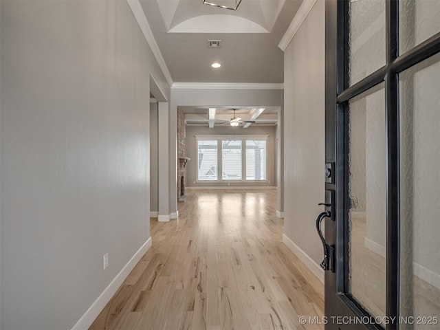 corridor with light wood finished floors, baseboards, coffered ceiling, ornamental molding, and beam ceiling