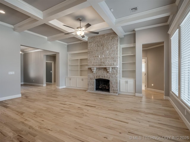 unfurnished living room featuring ceiling fan, coffered ceiling, visible vents, and a healthy amount of sunlight