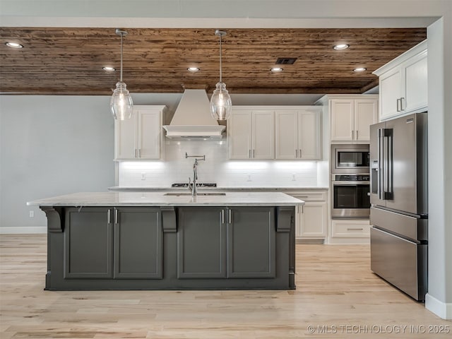 kitchen with wood ceiling, white cabinets, appliances with stainless steel finishes, tasteful backsplash, and custom range hood