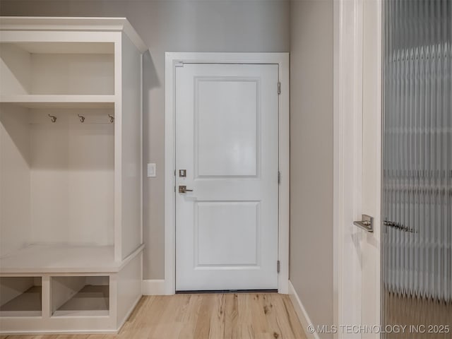 mudroom with light wood-type flooring and baseboards