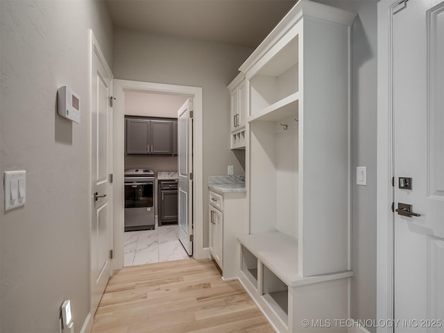 mudroom with light wood-style flooring