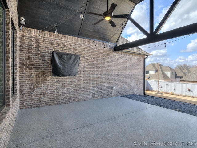 view of patio / terrace with ceiling fan and fence