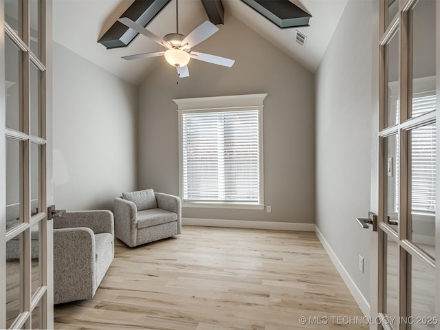 sitting room featuring french doors, visible vents, light wood-style flooring, a ceiling fan, and vaulted ceiling