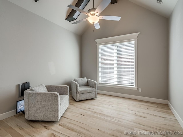 sitting room with light wood-style floors, vaulted ceiling, and a ceiling fan