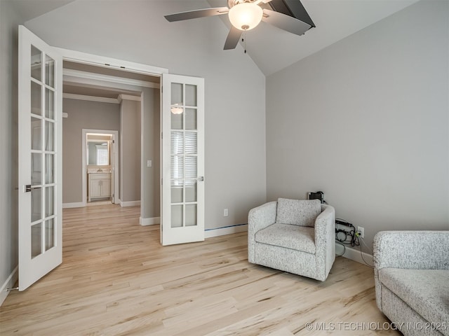 living area featuring french doors, lofted ceiling, a ceiling fan, light wood-type flooring, and baseboards