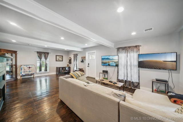 living area featuring visible vents, wood finished floors, a fireplace, beam ceiling, and recessed lighting