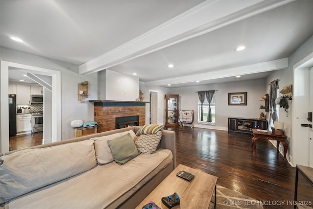 living room with a stone fireplace, recessed lighting, wood finished floors, baseboards, and beam ceiling