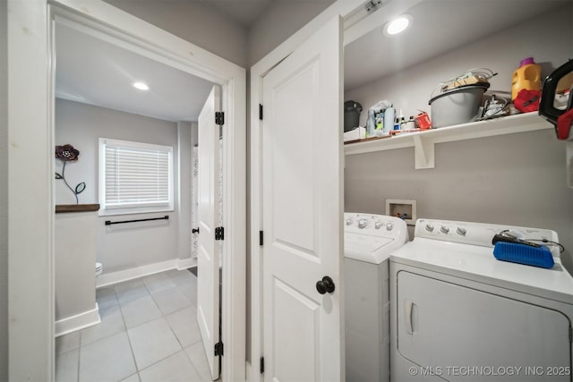 laundry area with light tile patterned floors, recessed lighting, laundry area, baseboards, and washer and clothes dryer