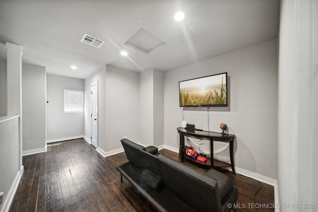 office featuring baseboards, wood-type flooring, visible vents, and attic access