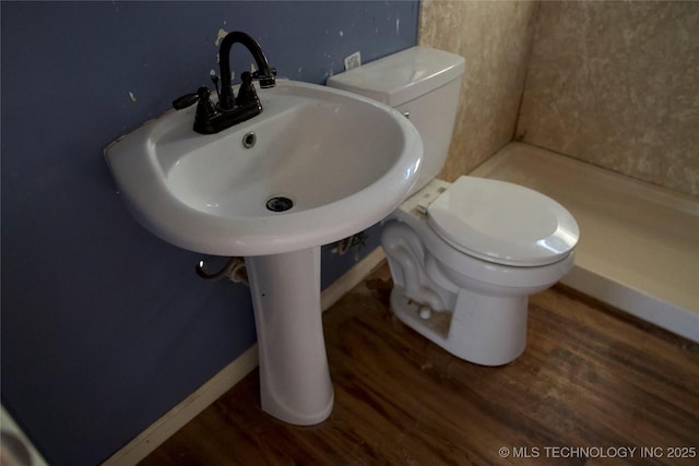 bathroom featuring baseboards, toilet, and wood finished floors