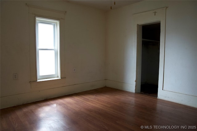 spare room with wood finished floors