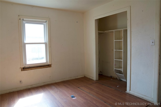 unfurnished bedroom featuring a closet and wood finished floors