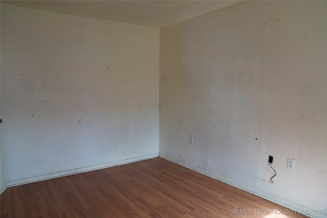 unfurnished room featuring wood finished floors