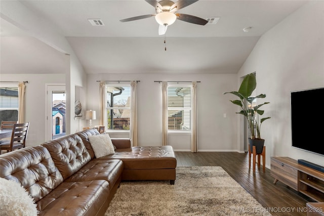 living area with vaulted ceiling, wood finished floors, visible vents, and a ceiling fan