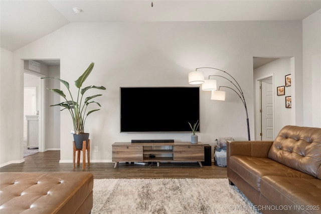 living room with lofted ceiling, wood finished floors, and baseboards