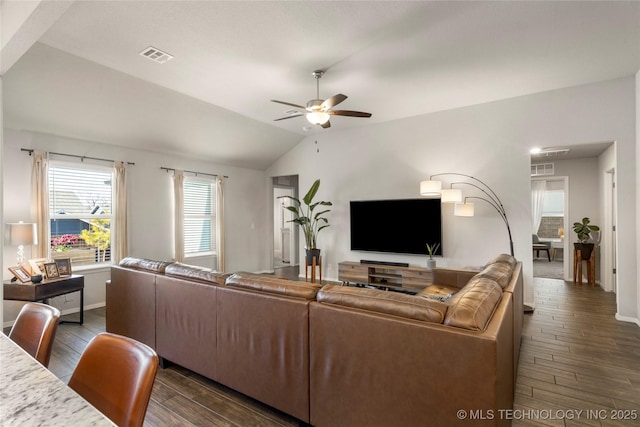 living room featuring vaulted ceiling, ceiling fan, dark wood finished floors, and visible vents