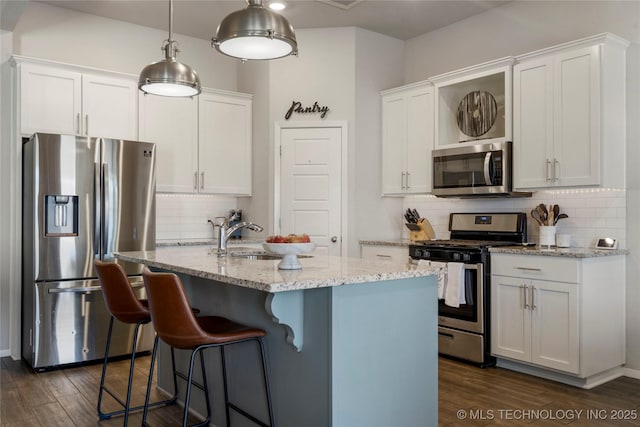 kitchen featuring white cabinetry, appliances with stainless steel finishes, dark wood finished floors, and a sink