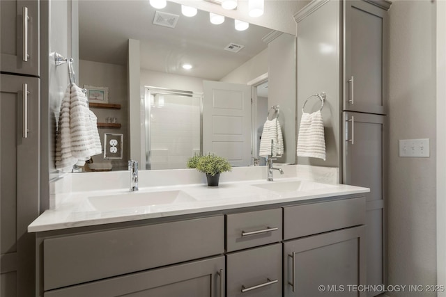 bathroom featuring double vanity, a sink, visible vents, and a shower stall