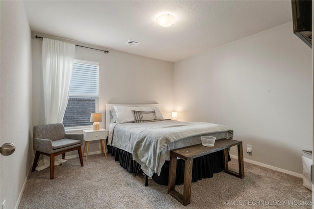 bedroom with baseboards, visible vents, and carpet flooring