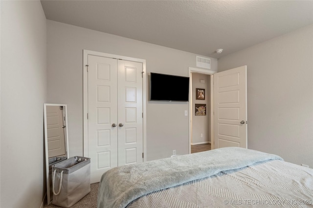 bedroom featuring visible vents and a closet