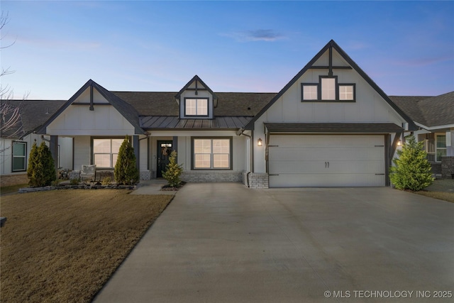 view of front of property featuring metal roof, a garage, brick siding, concrete driveway, and a standing seam roof