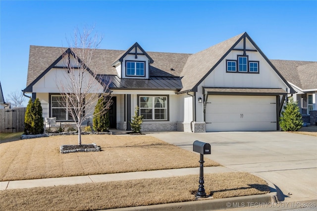 view of front of home with driveway, a shingled roof, metal roof, an attached garage, and brick siding