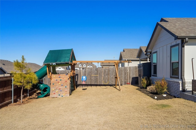 exterior space with a playground and fence