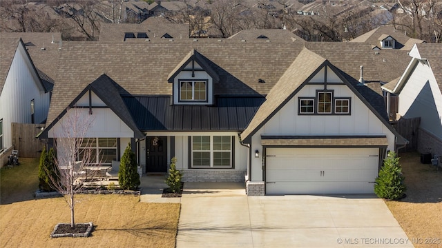 view of front of property with brick siding, concrete driveway, board and batten siding, a standing seam roof, and metal roof