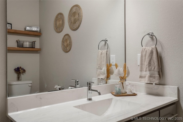 bathroom with toilet and vanity