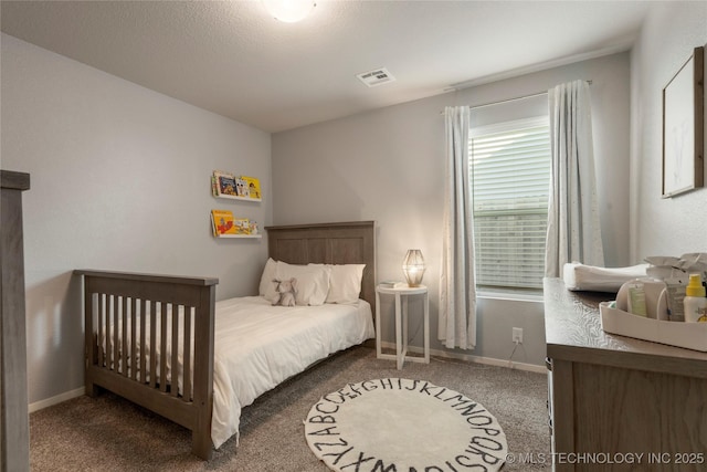 bedroom featuring carpet floors, visible vents, and baseboards