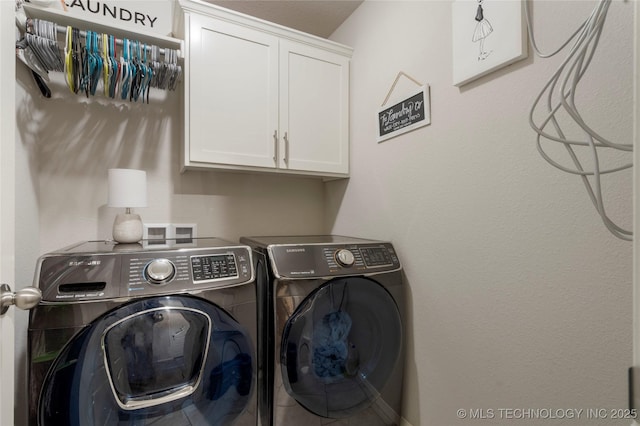 laundry area with cabinet space and independent washer and dryer