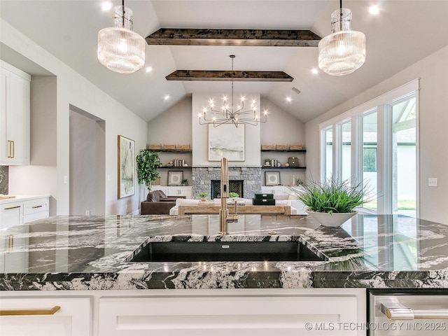 11225 S Fir Ave W, Jenks, OK 74037 - kitchen featuring white cabinets, a fireplace, lofted ceiling with beams, and a sink