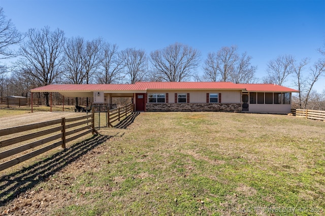 single story home featuring an outbuilding, metal roof, dirt driveway, and an exterior structure