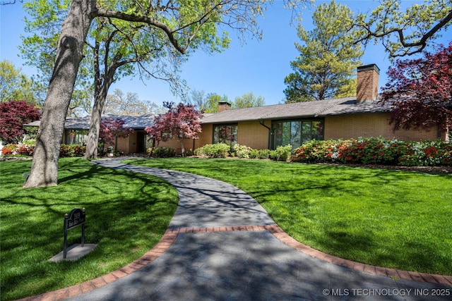 view of front of home with a front lawn and a chimney