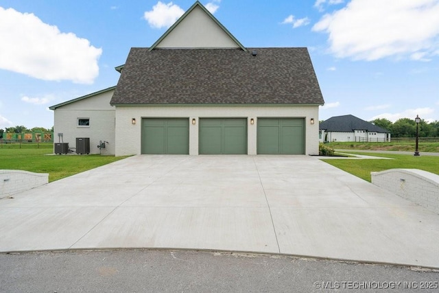 view of property exterior with central AC unit, a garage, a shingled roof, a yard, and driveway