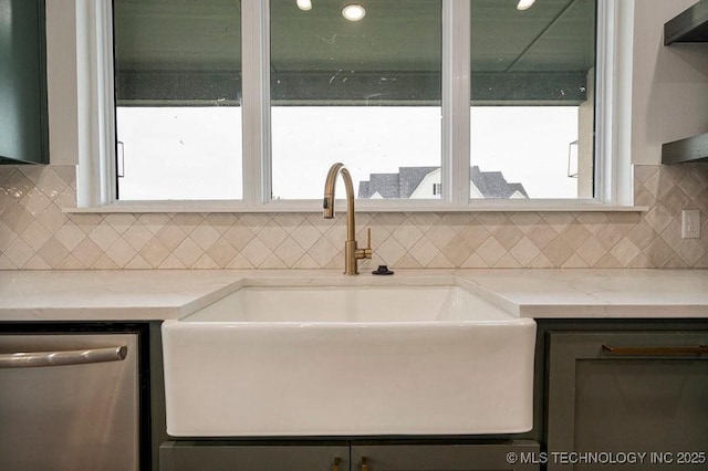 kitchen featuring light stone counters, extractor fan, a sink, decorative backsplash, and dishwasher