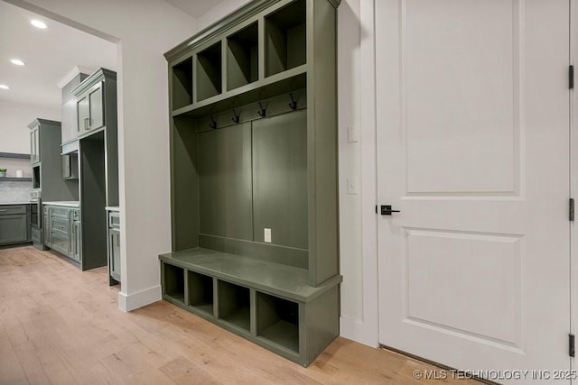 mudroom with recessed lighting, light wood-style flooring, and baseboards