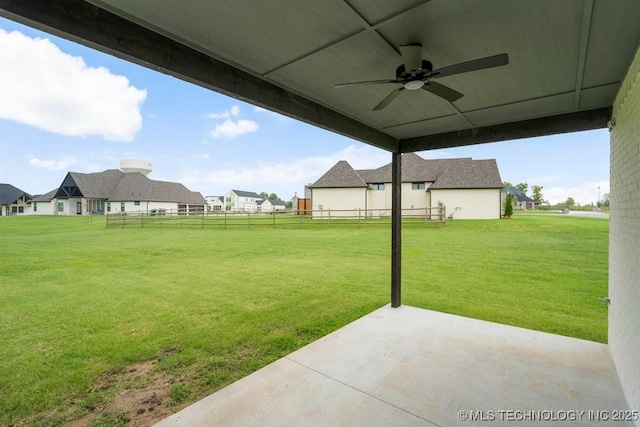 view of yard featuring a residential view, a patio area, ceiling fan, and fence