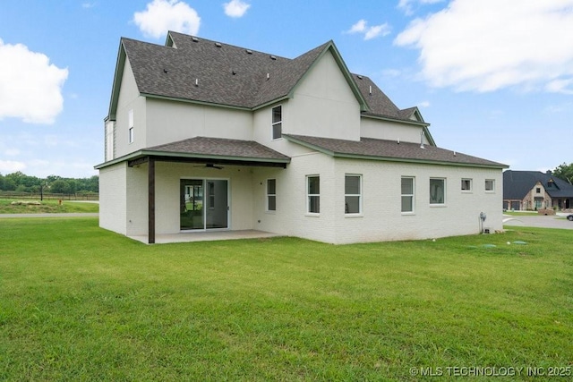 back of house with a patio area, a shingled roof, a ceiling fan, and a lawn