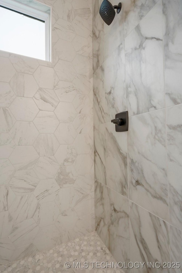 bathroom with a tile shower