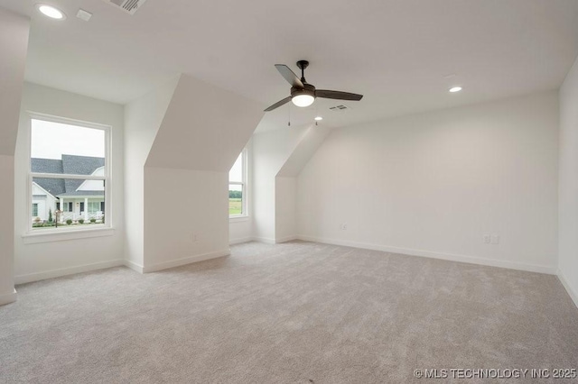 additional living space with ceiling fan, recessed lighting, light colored carpet, visible vents, and baseboards