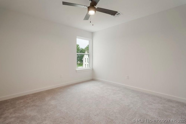 unfurnished room with light colored carpet, ceiling fan, visible vents, and baseboards