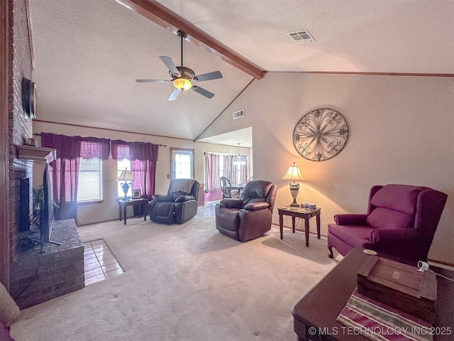 living room featuring visible vents, lofted ceiling with beams, a textured ceiling, carpet flooring, and a brick fireplace