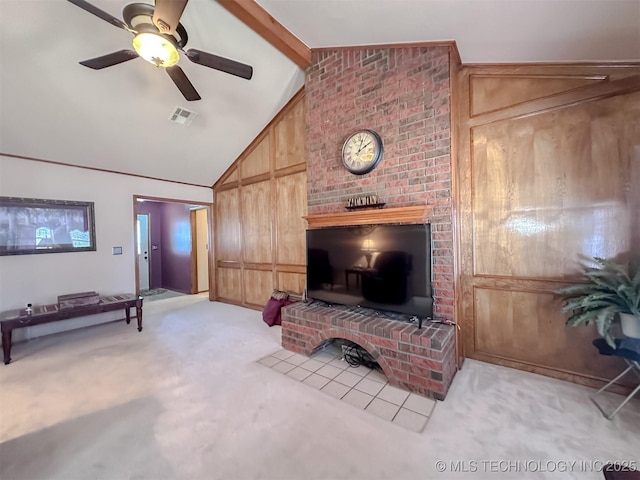 living room featuring light carpet, visible vents, ceiling fan, wood walls, and beam ceiling